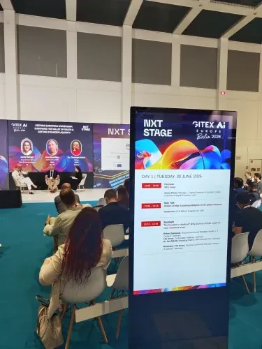 Stage screen showing the live agenda at the GITEX conference