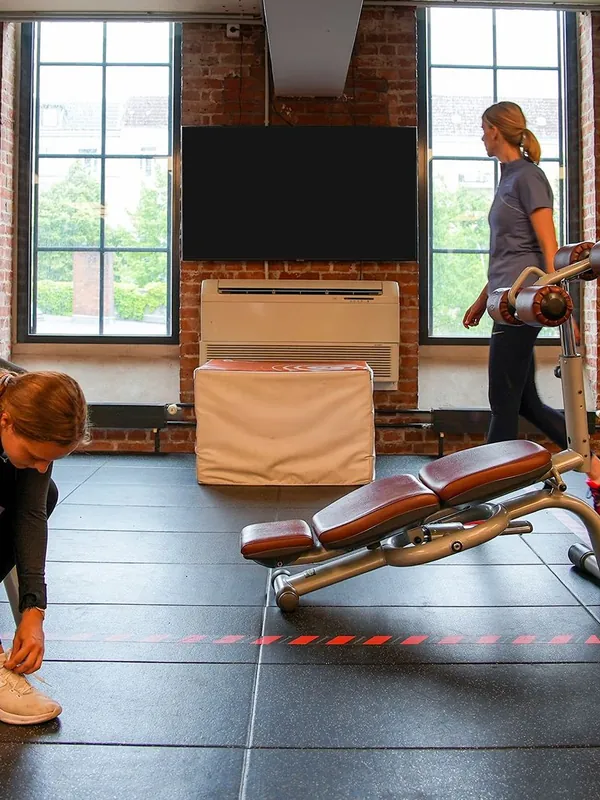 Representative photo: a screen on the wall of a gym training area
