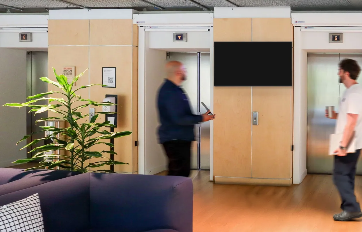A screen between the lifts of an office building